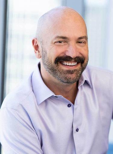 Portrait of Norm Yustin, leadership advisor at Russell Reynolds Associates