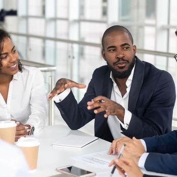 rra-black-millennial-boss-leading-corporate-team-iStock-1139630453.jpg